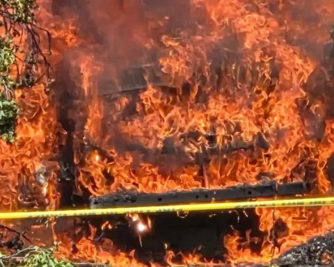 Firefighters battle a multi-vehicle fire after a fallen tree limb brought down power lines at The Grand Apartments in Cherry Hill, leaving residents without electricity.