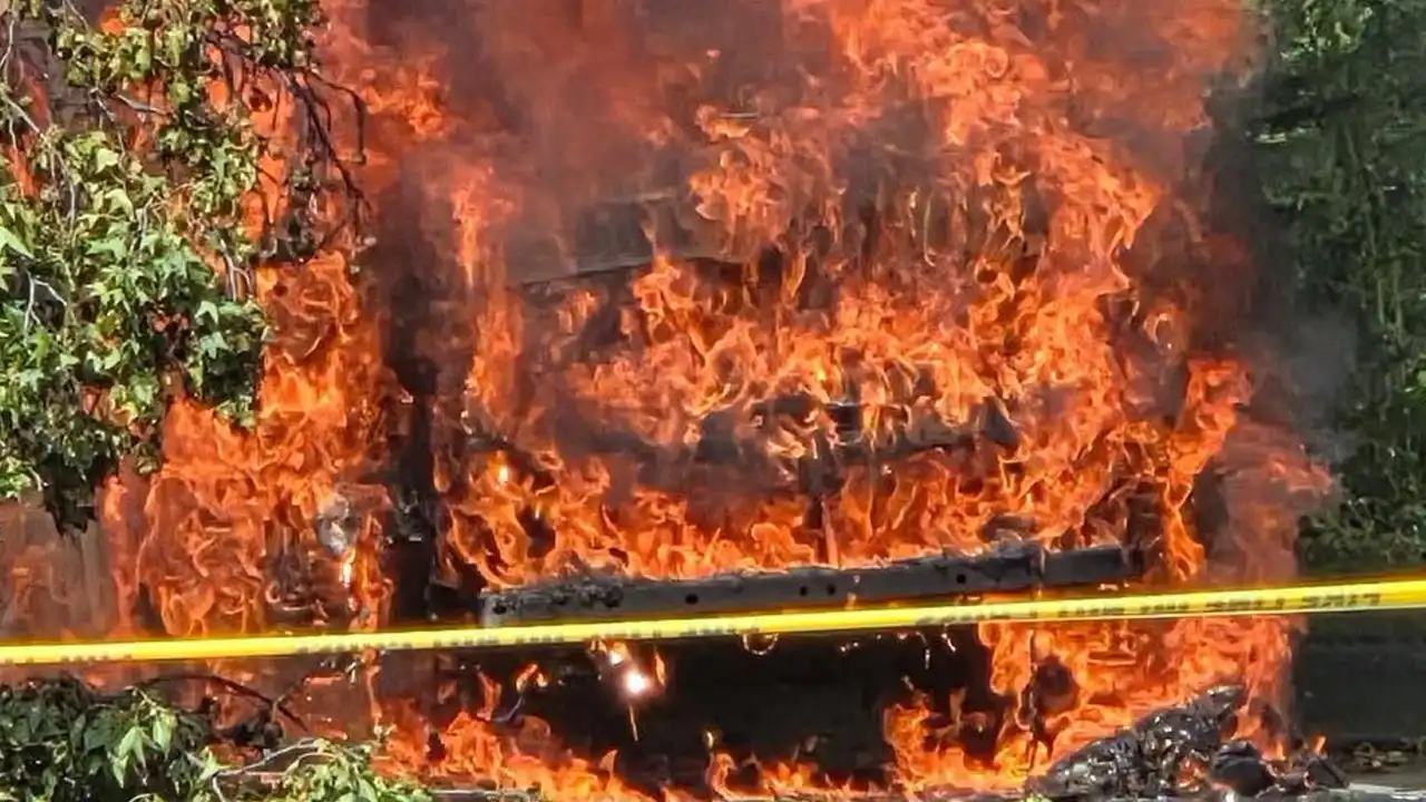 Firefighters battle a multi-vehicle fire after a fallen tree limb brought down power lines at the grand apartments in cherry hill, leaving residents without electricity.