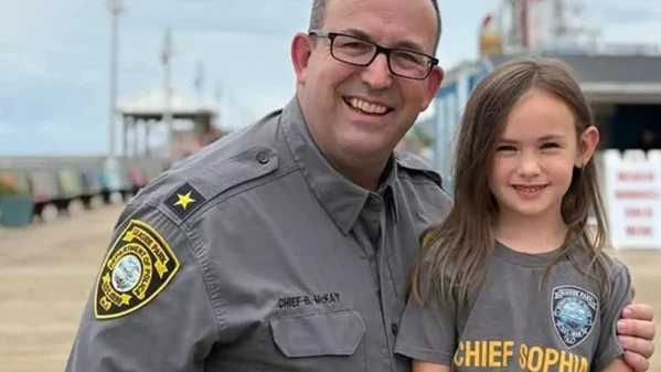 Photo Caption: Chief Sophia poses with members of the Seaside Park Police Department after spending the day serving as the department's first honorary "Chief of the Day." Photo by Seaside Park Police Dept. / Facebook