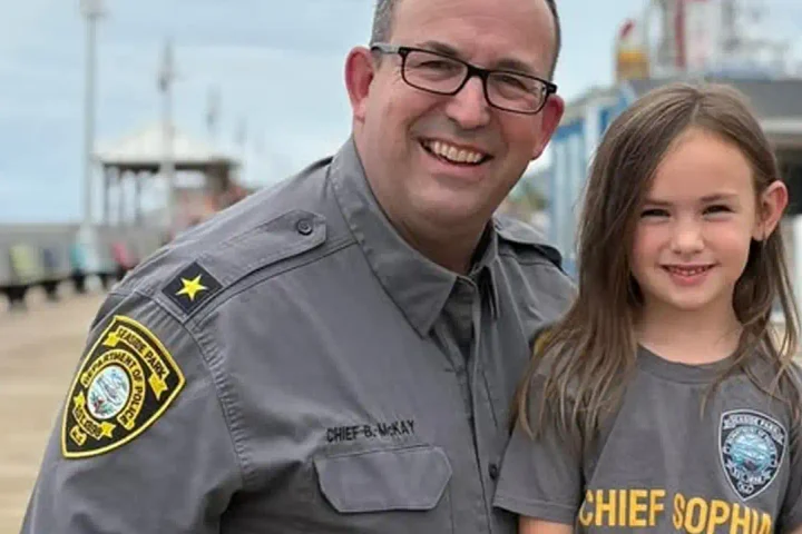 Photo Caption: Chief Sophia poses with members of the Seaside Park Police Department after spending the day serving as the department's first honorary "Chief of the Day." Photo by Seaside Park Police Dept. / Facebook