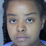 According to investigators, Nolte-Maple is accused of knowing that an acquaintance, identified as Raheem Floyd, used a lighter to burn a small child while the child was unable to move.