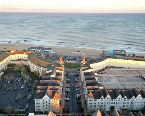 A drone shot of the Pier Village in Long Branch, New Jersey, and the Atlantic Ocean at sunset