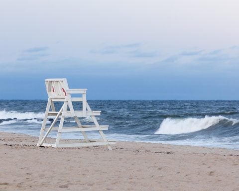 Asbury Park New Jersey Lifeguard Chair. An empty Asbury Park Beach Patrol lifeguard chair faces the Atlantic Ocean during the evening at sunset. Photo by Erin Cadigan