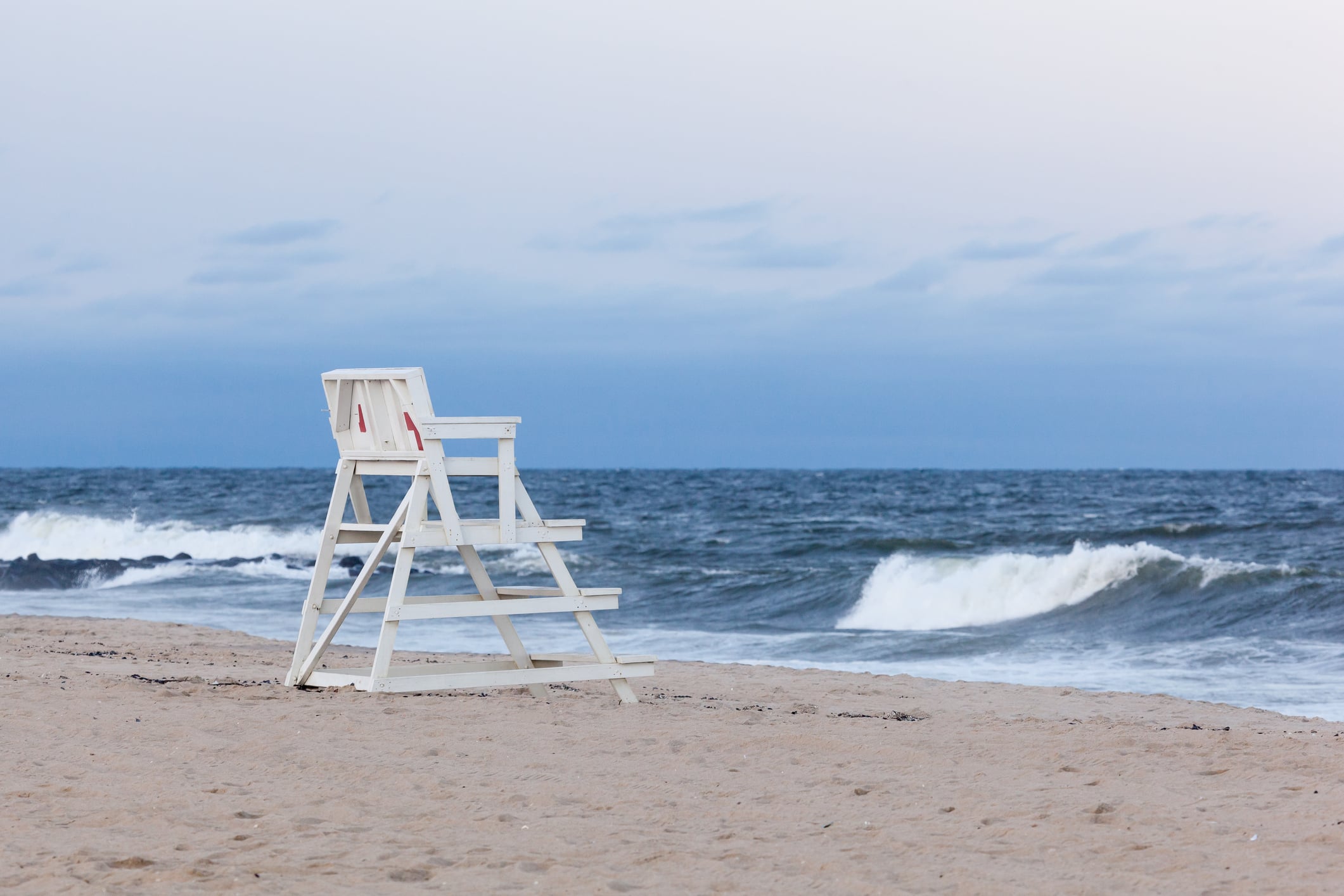 Asbury park new jersey lifeguard chair. An empty asbury park beach patrol lifeguard chair faces the atlantic ocean during the evening at sunset. Photo by erin cadigan