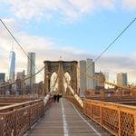 NYPD officers shot a knife-wielding man on the Brooklyn Bridge early Friday, closing parts of the span and snarling the morning commute in NYC.