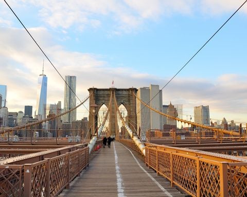 NYPD officers shot a knife-wielding man on the Brooklyn Bridge early Friday, closing parts of the span and snarling the morning commute in NYC.