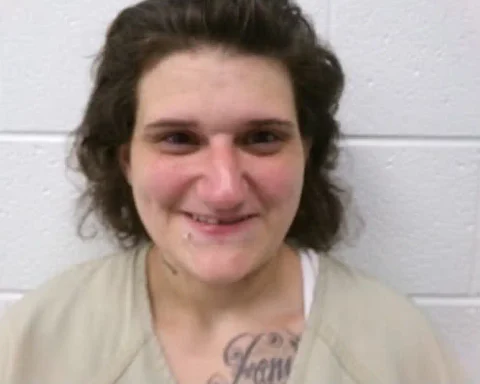 A Cumberland woman is being held without bond on arson and explosives charges after investigators said she intentionally set a July porch fire.