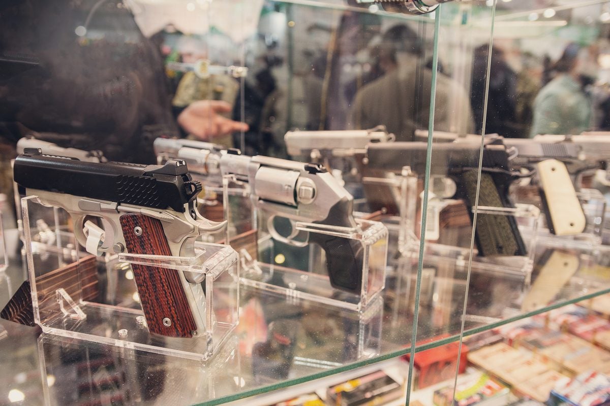 Two handguns displayed on a gun-store counter as gun rights groups challenge New Jersey’s one-handgun-per-30-days purchase restriction in federal court.