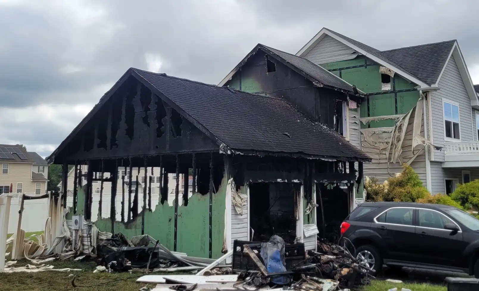 Five people escaped a Denton house fire sparked by discarded smoking materials Sunday, with damage estimated at $300,000 and a family cat still missing.