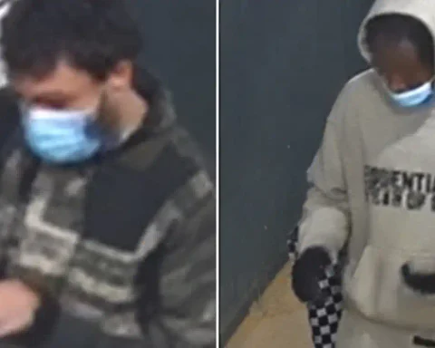 NYPD is searching for two suspects accused of displaying a firearm and stealing a man's wallet, cellphone and backpack during a Queens robbery