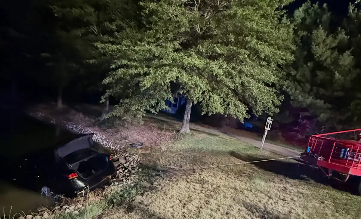 Manchester police officers rescued a driver before a vehicle became completely submerged in a body of water inside the Renaissance development early Sunday.