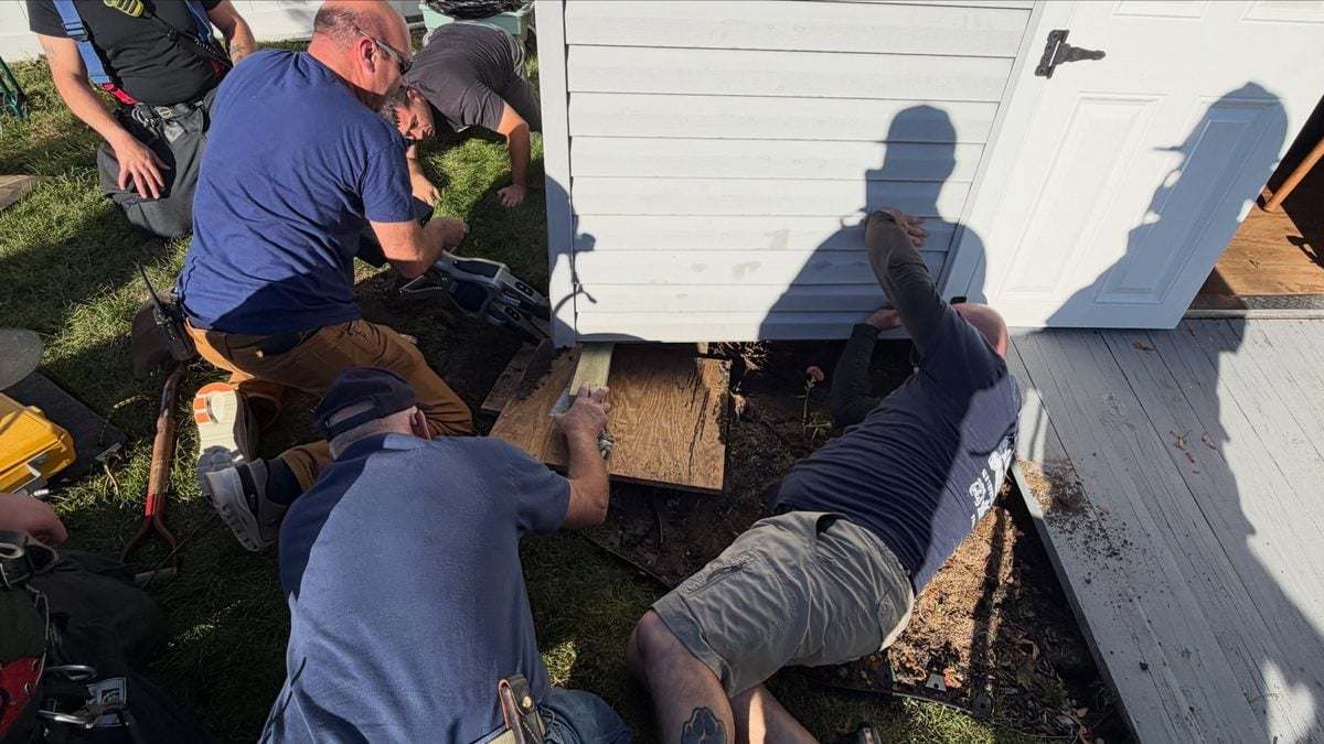 Long island firefighters use jaws of life to rescue dog trapped beneath backyard shed