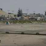 Shore town flooded during storm deals with ev battery fire aftermath, abandoned vehicles
