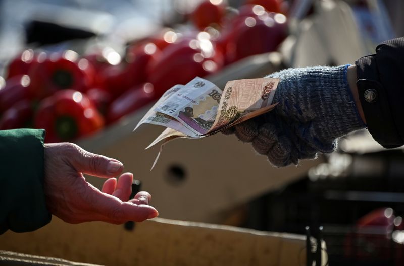 Russian rouble, stocks steady, defy global volatility