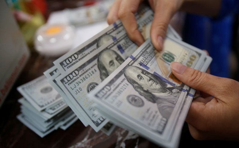 Dollar pares gains as some Fed officials show caution on growth