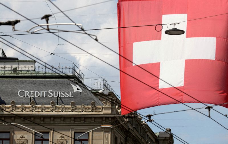 Credit Suisse shares hit record low after report bank is looking to raise cash