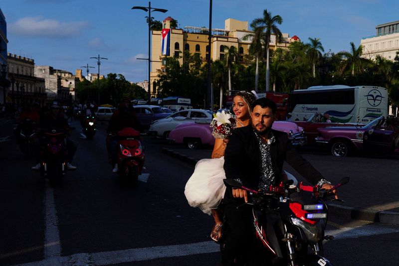 Electricity in the air for one Cuban couple's two-wheeler wedding procession