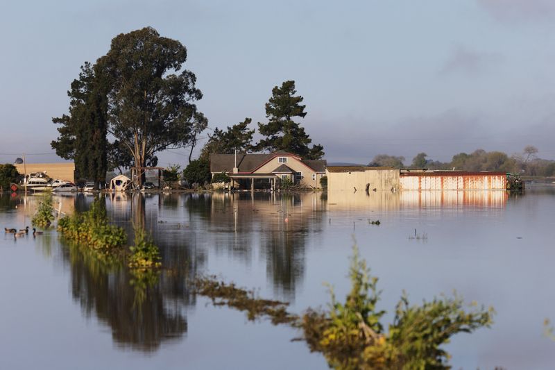 California flooded with rain, Northeast buried under snow
