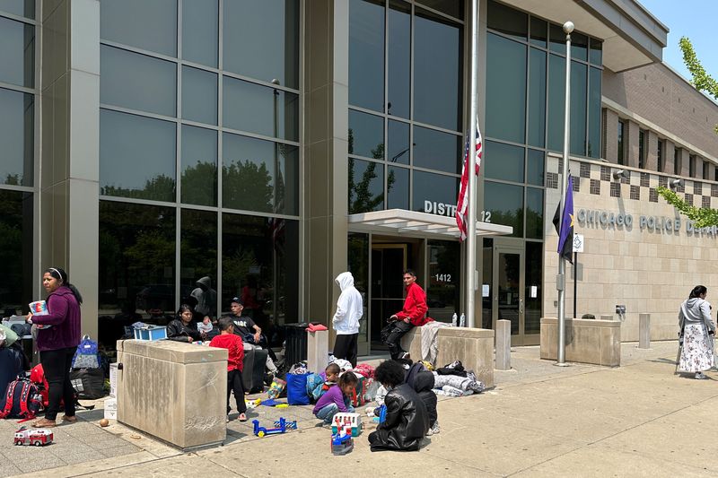 Migrants sleep in Chicago police stations as shelters strain