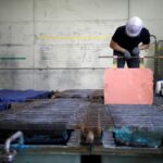 FILE PHOTO: An employee holds a recycled copper plate at