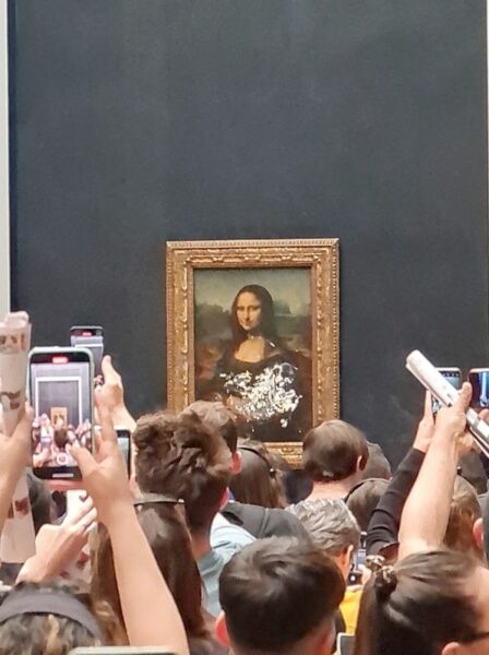Mona lisa left unharmed but smeared in cream in climate protest stunt