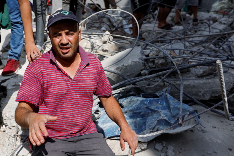 Palestinians sift through rubble at Gaza camp hit in Israeli strike