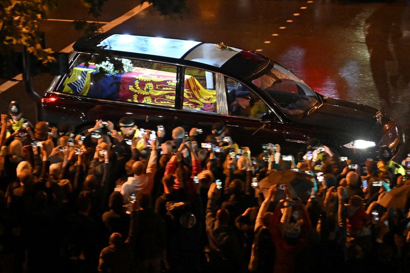 Queen's coffin arrives at Buckingham Palace as huge crowds line London route