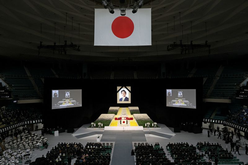 With flowers and a gun salute, Japan bids farewell to divisive Abe