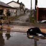 Bodies of civilians lie down on the street, amid Russia’s