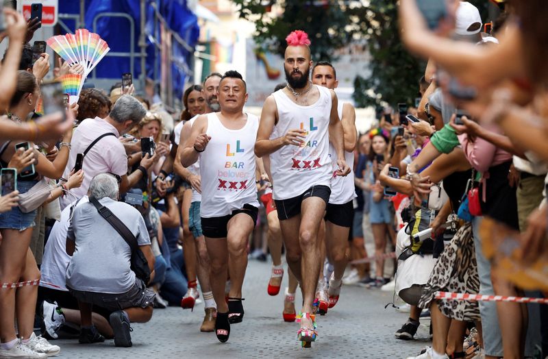 Ready, try to stay steady, go! Men in high heels race at Madrid Pride