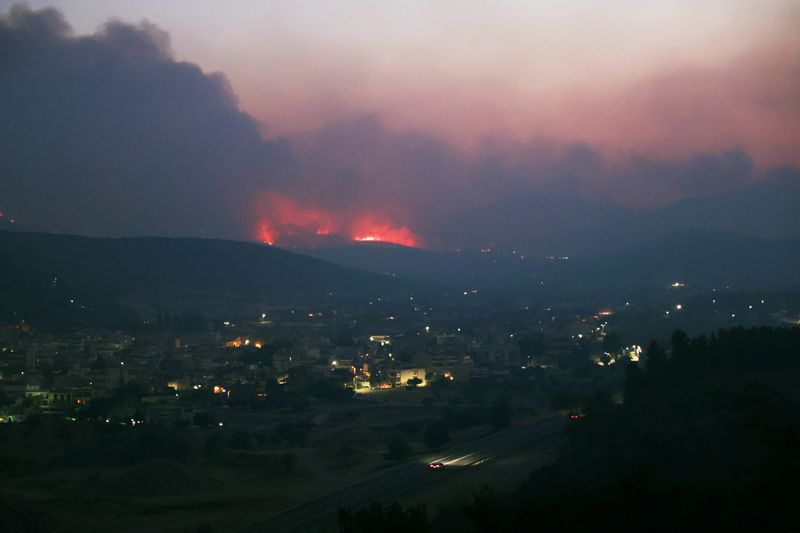 Wildfires northwest of Athens rage into the night, burn homes