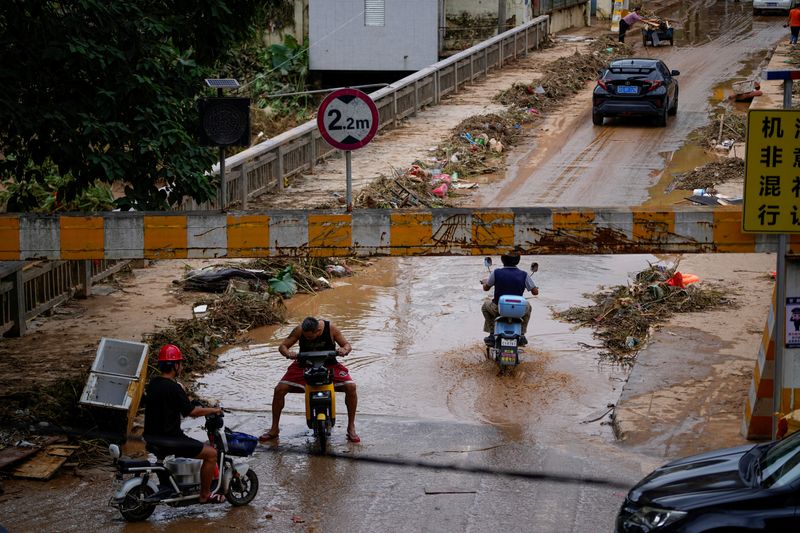 South China small businesses start to count cost of record rains