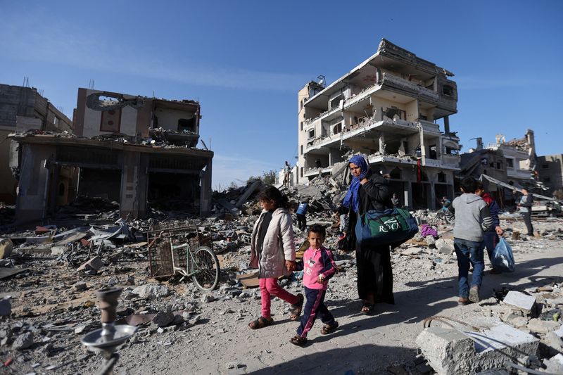 Happy but wary, displaced Palestinians try to head home to north Gaza