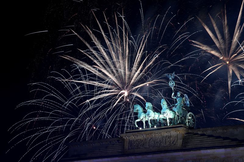 World welcomes New Year with fireworks, some stark words and a royal farewell