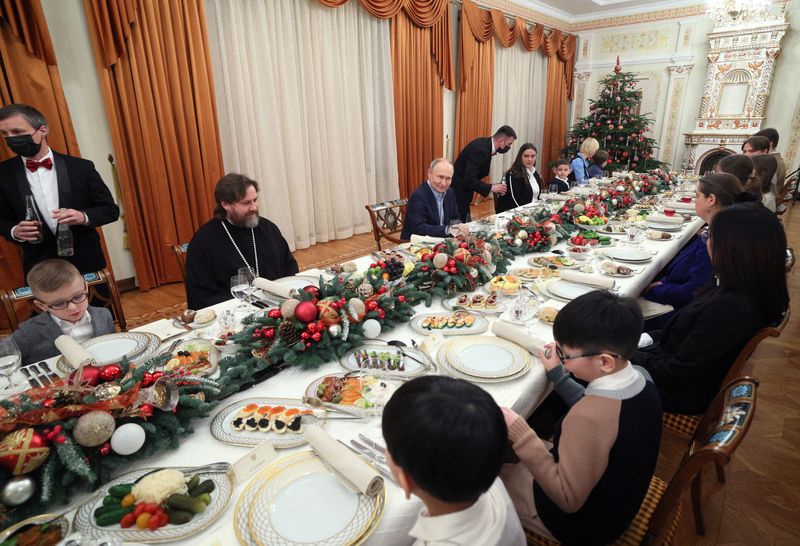 On Orthodox Christmas Putin vows to back soldiers who 'defend' Russia