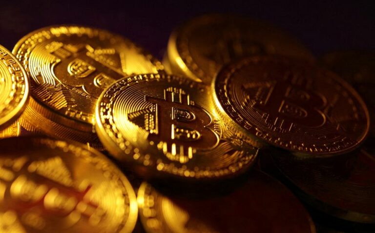 Shiny gold Bitcoin coins stacked together