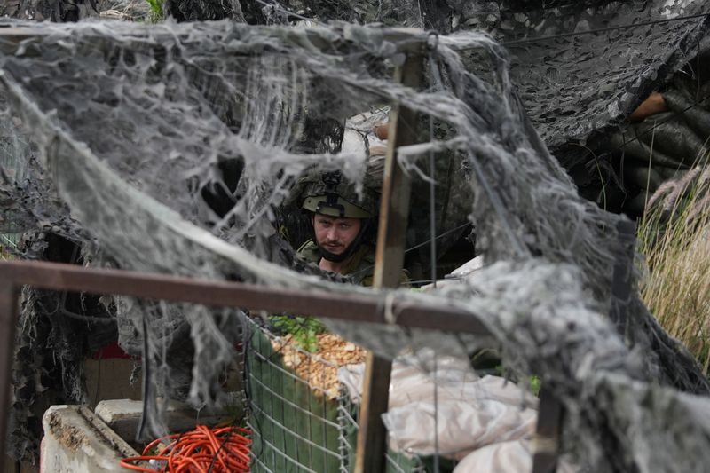 Israeli soldiers on northern border dig in and wait as tensions mount