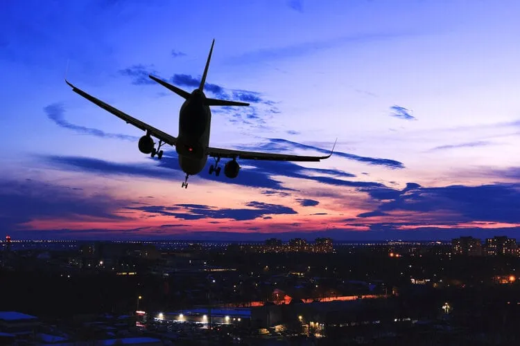 Fully vaccinated 36-year-old flight attendant loses month-long fight against COVID-19 Passenger plane landing. Stock Photo.