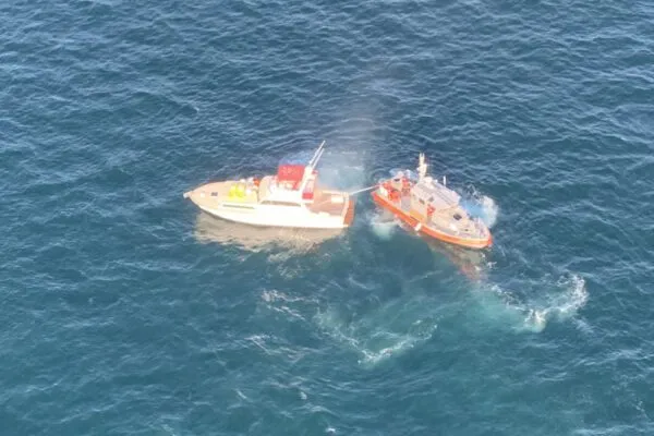 Three rescued from burning boat by Coast Guard Three rescued from burning boat by Coast Guard