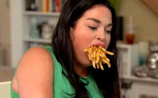 She has the world's biggest mouth and can shove two cheeseburgers in it at once She has the world's biggest mouth and can shove two cheeseburgers in it at once