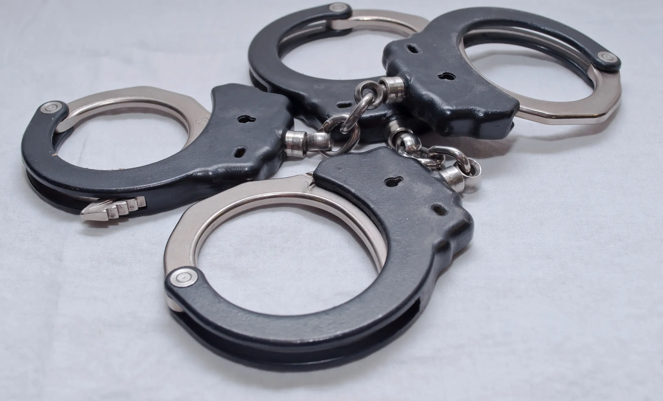 Texas Father and Son Arrested in Murder of Pregnant Teen and Boyfriend Two sets of handcuffs.